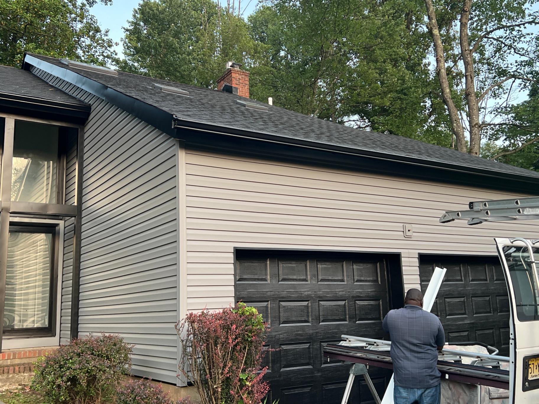 Worker Installing House Siding Planks
